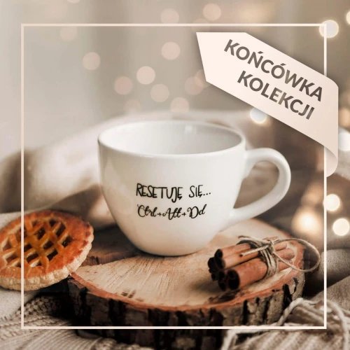 Biały kubek porcelanowy Nadzwyczajnie.pl ze złotym zdobieniem i napisem Resetuję się... ctrl + alt + del | końcówka