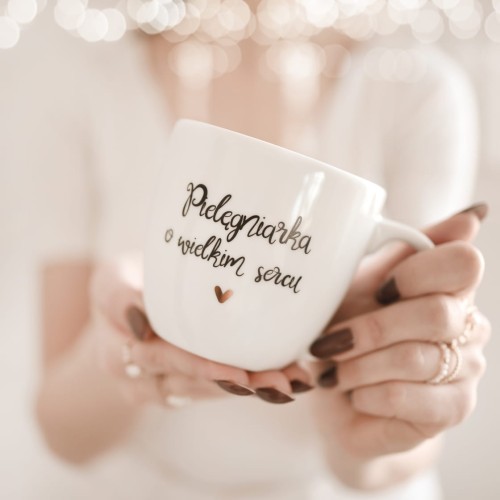 Biały kubek porcelanowy Nadzwyczajnie.pl ze złotym sercem i napisem Pielęgniarka o wielkim sercu — 300 ml