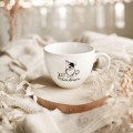 Biały kubek porcelanowy 500 ml - motyw psa i napisu jest PSIEcudownie dla miłośnika psów na urodziny Biały kubek porcelanowy Nadzwyczajnie.pl ze złotym zdobieniem i napisem Jest PSIEcudownie — 500 ml
