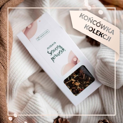 Biały produkt porcelanowy Nadzwyczajnie.pl ze złotym zdobieniem i napisem Herbata - Śnieżny poranek - świąteczna 50g